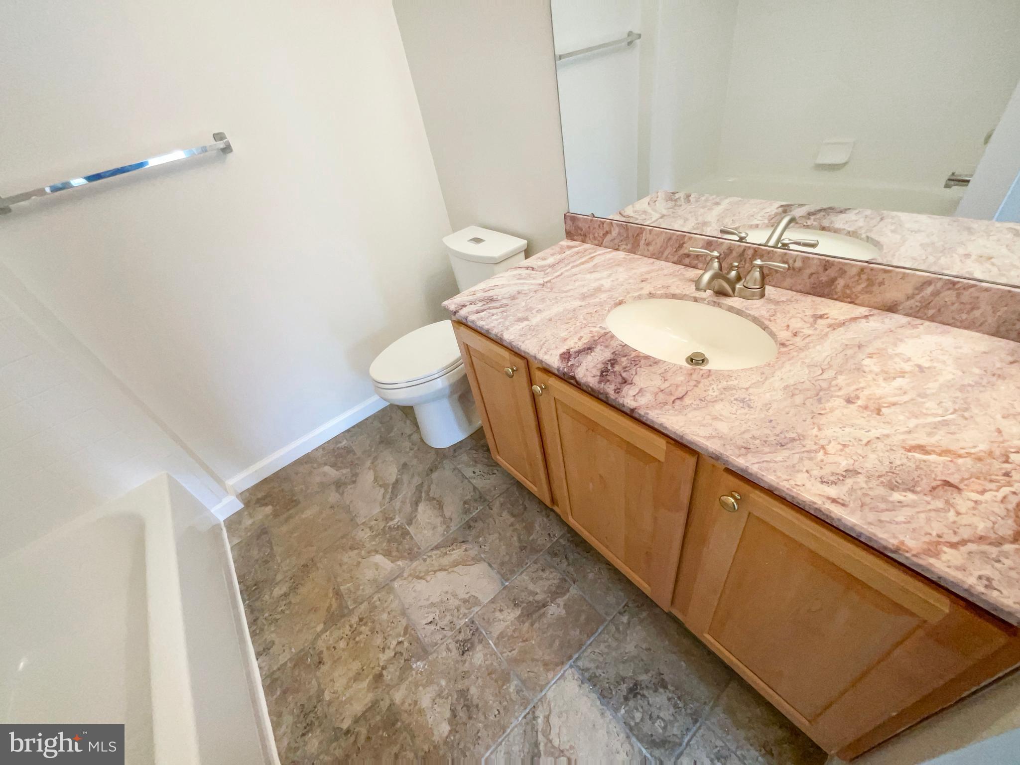14272 Glade Spring Drive Centreville, VA 20121 - Photo 24 of 46 a bathroom with a granite countertop sink a toilet and a mirror