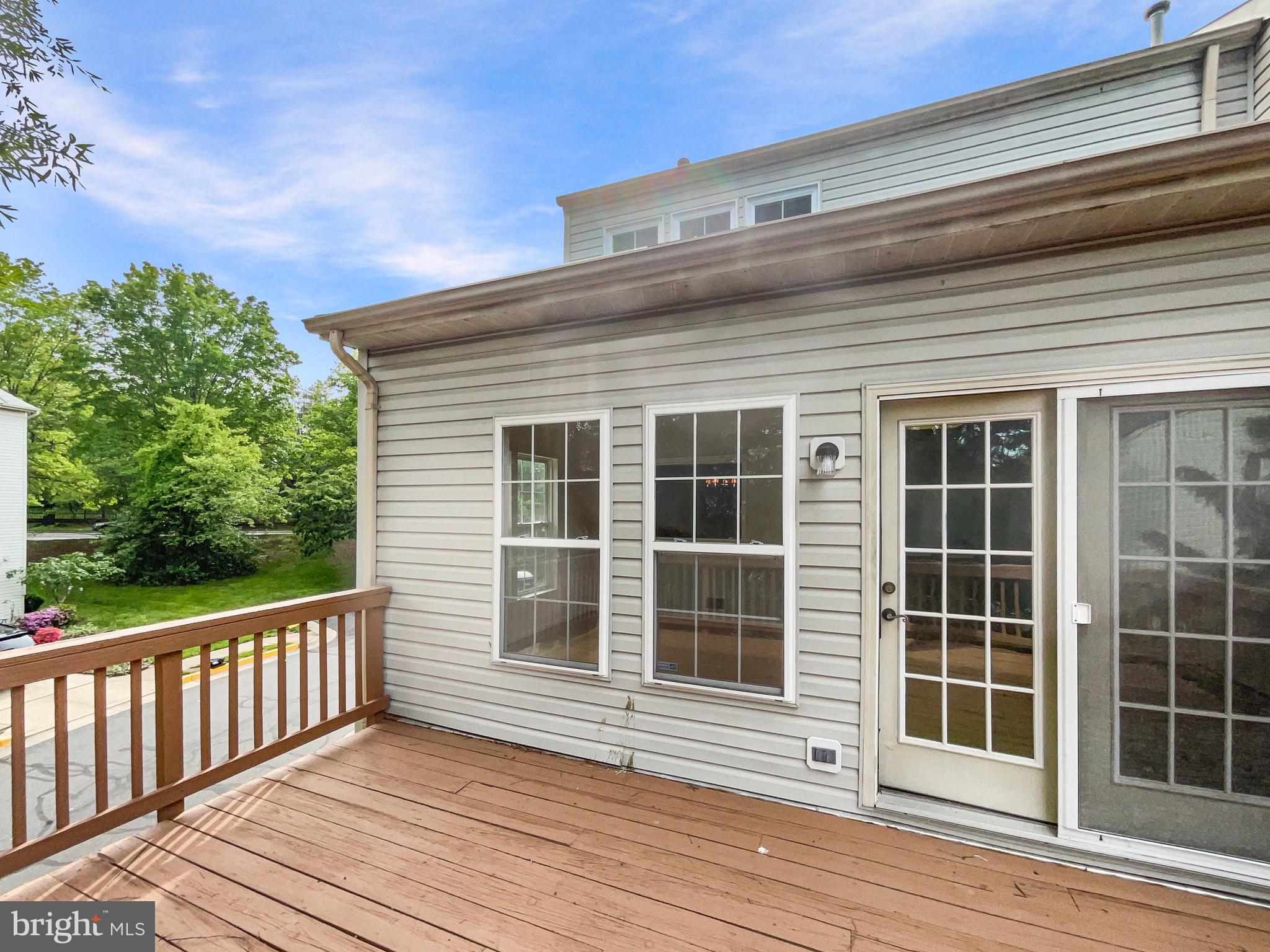 14272 Glade Spring Drive Centreville, VA 20121 - Photo 44 of 46 a view of a balcony with wooden floor and fence and a floor to ceiling window