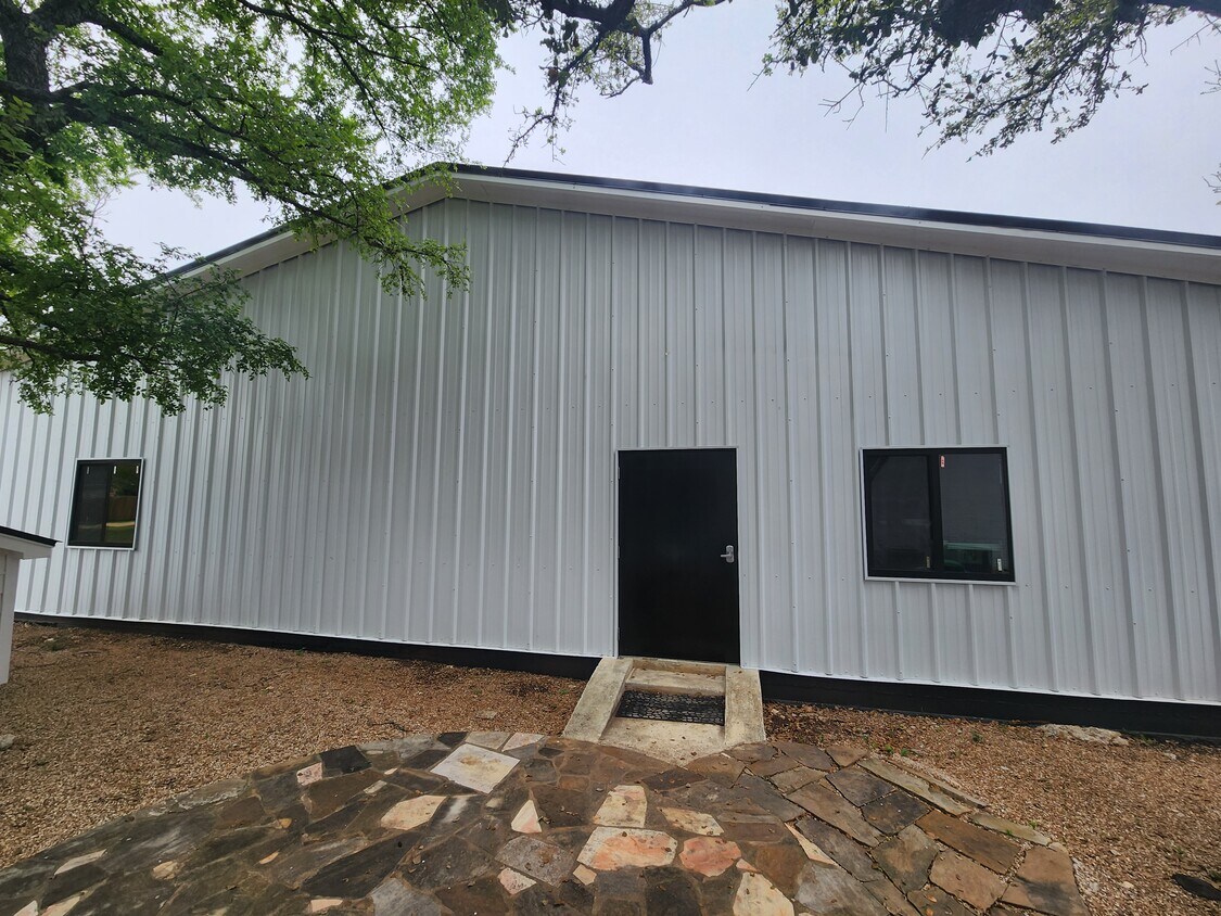 102 County Road 180 Leander, TX 78641 - Photo 20 of 25 A well-maintained metal building, ideal for various uses, boasts a secure entrance.