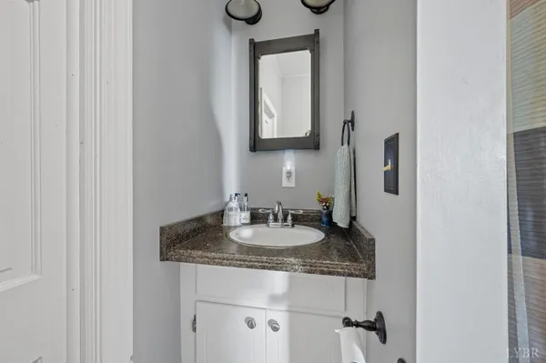 a bathroom with a sink a toilet and a mirror