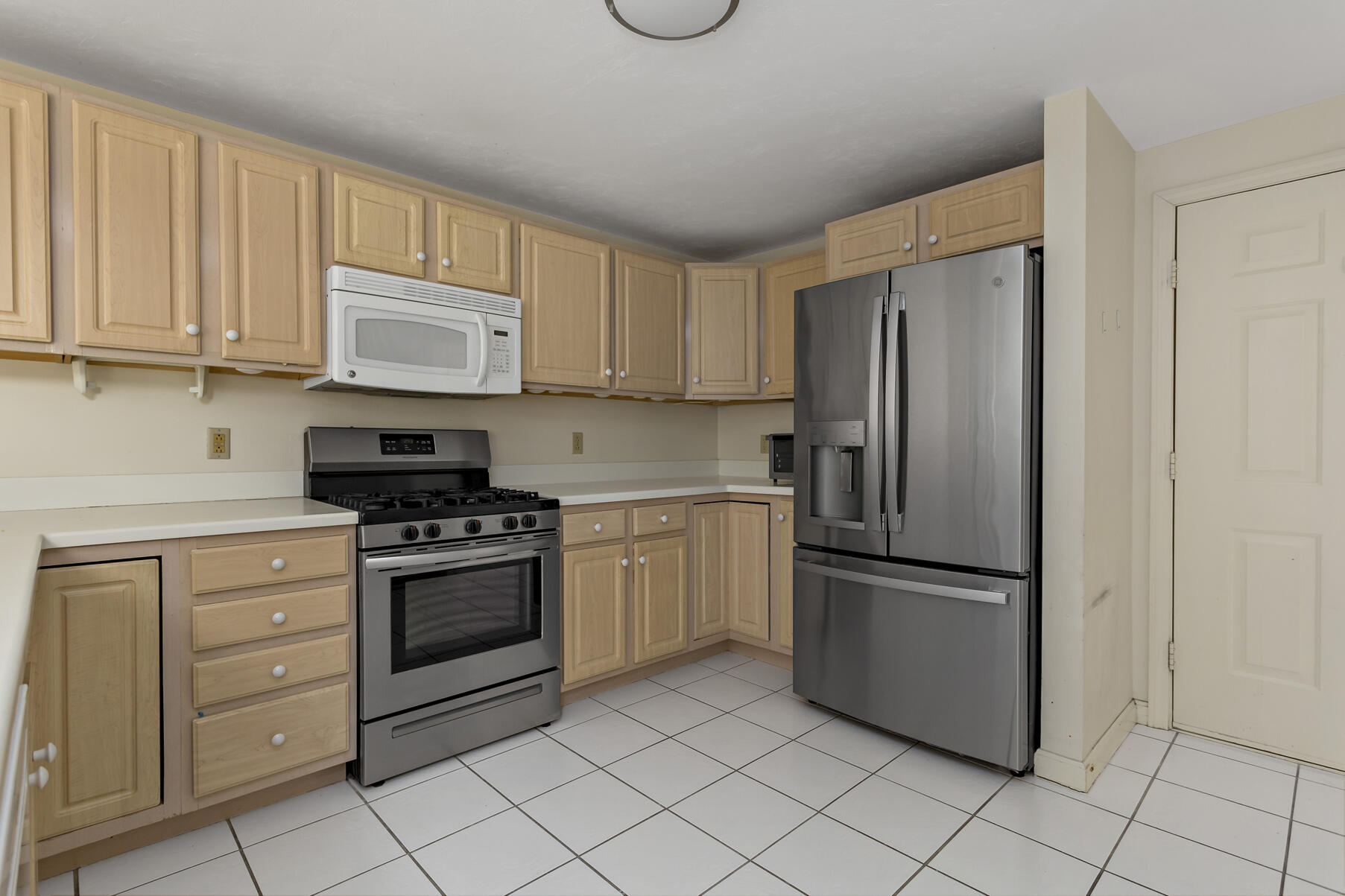 3 Kettle Lane Mashpee, MA 02649 - Photo 6 of 25 a kitchen with stainless steel appliances granite countertop a refrigerator sink and cabinets