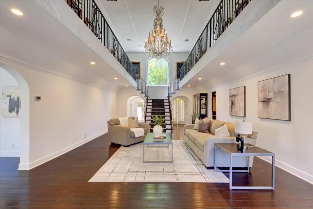 a living room with fireplace furniture and a chandelier