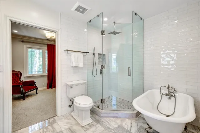 a spacious bathroom with a toilet a sink and a shower