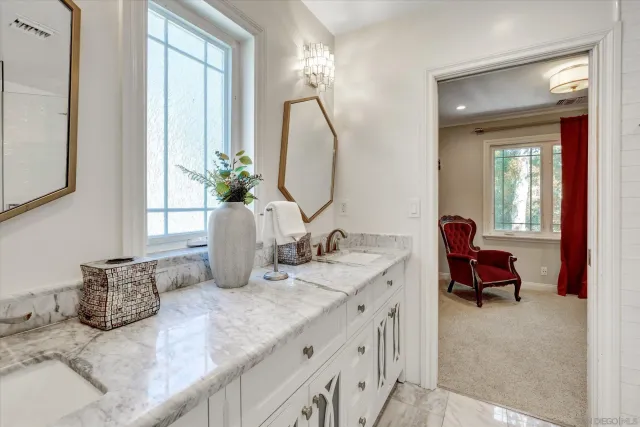 a bathroom with double vanity sinks and a mirror