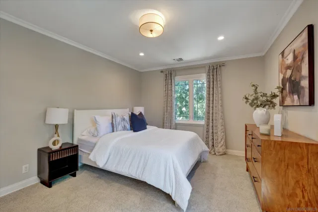 a bedroom with a bed and a lamp