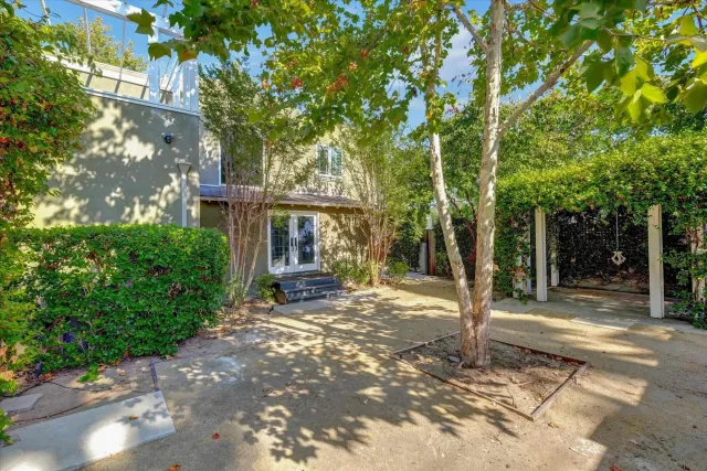 a view of a house with backyard porch and sitting area