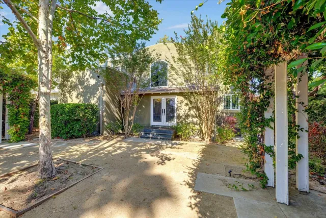a view of a house with a tree in the background