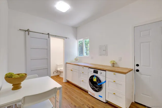 a utility room with cabinets and appliances