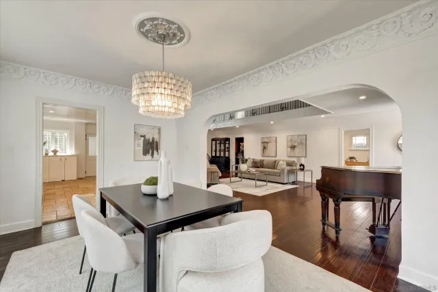 a view of a dining room with furniture and chandelier