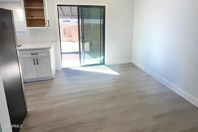 a kitchen with a refrigerator a sink and cabinets