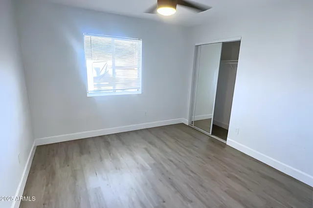 a white toilet sitting next to a bath tub