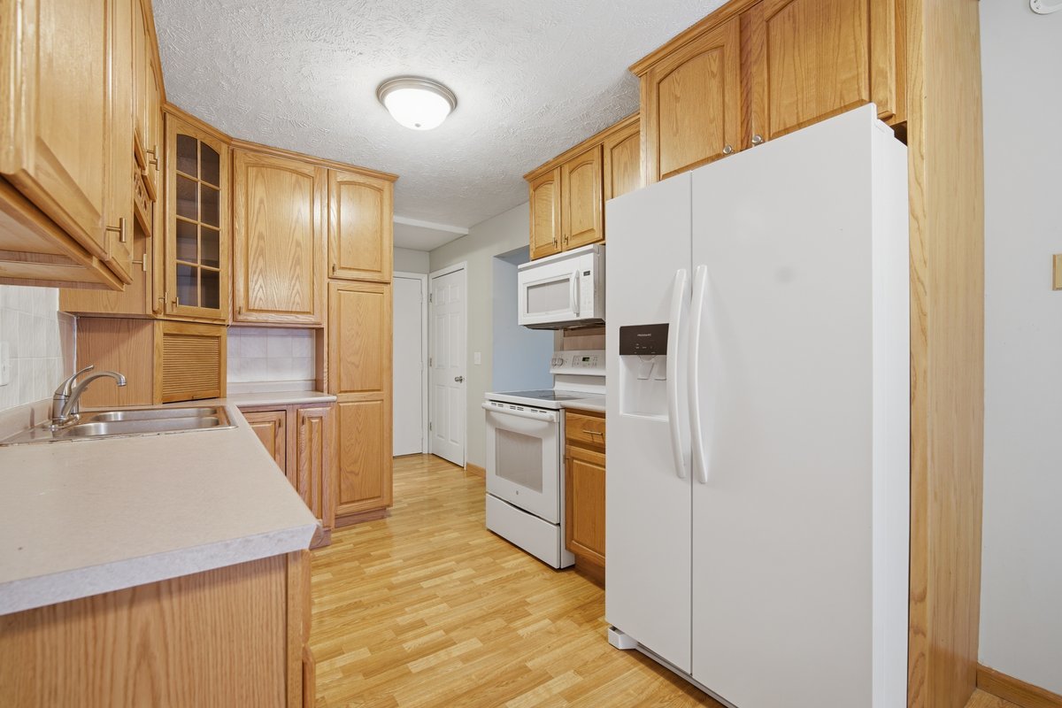 1532 Hunt Drive, Unit A Normal, IL 61761 - Photo 9 of 25 a kitchen with stainless steel appliances a refrigerator and a stove