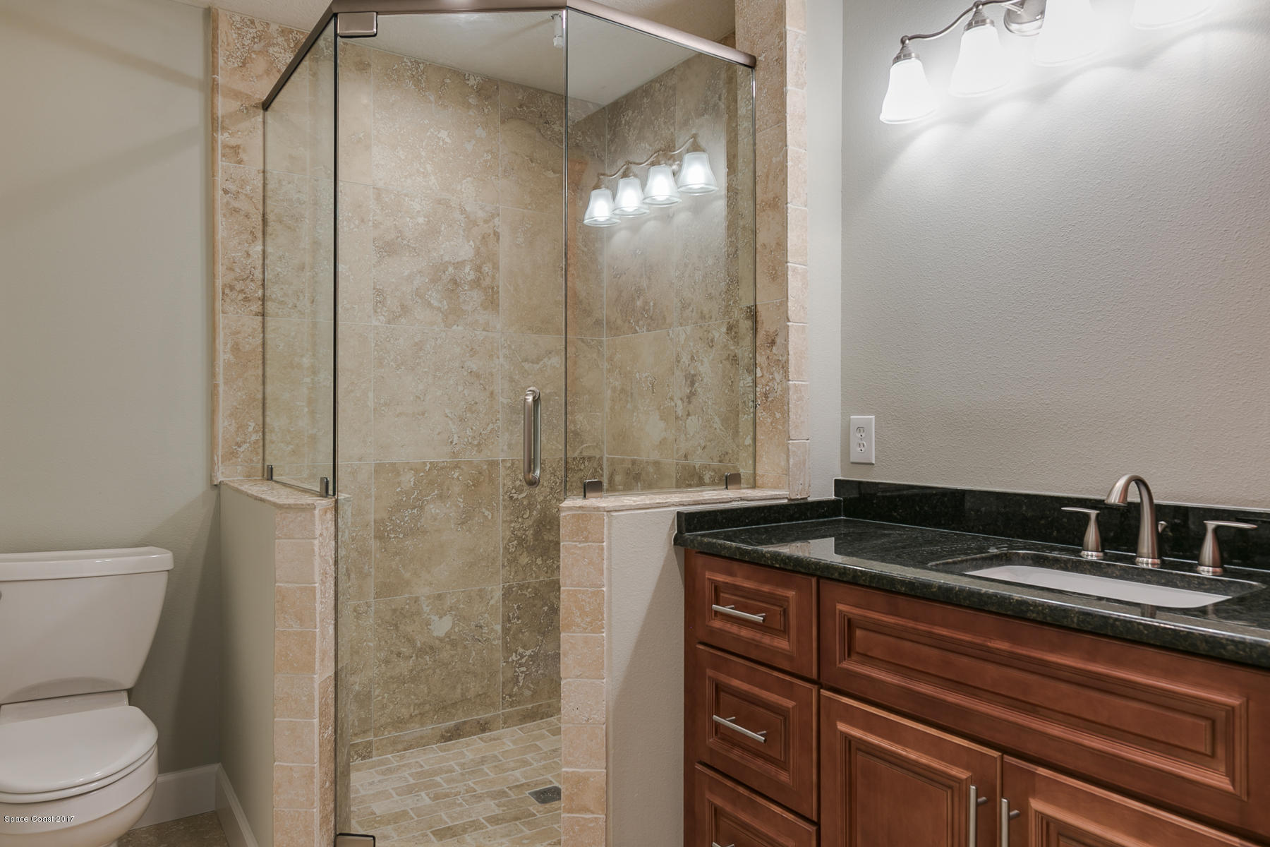 515 Rio Lane Melbourne, FL 32903 - Photo 11 of 15 a bathroom with a granite countertop sink a toilet and shower