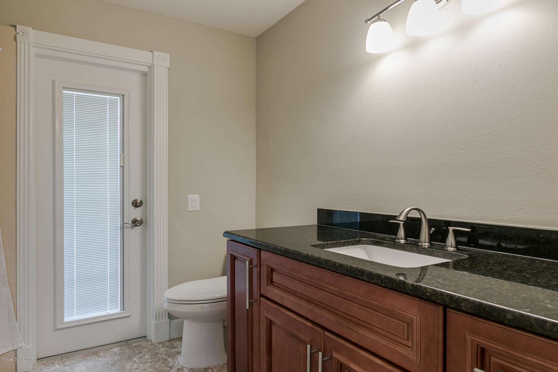 515 Rio Lane Melbourne, FL 32903 - Photo 13 of 15 a bathroom with a granite countertop sink toilet and shower
