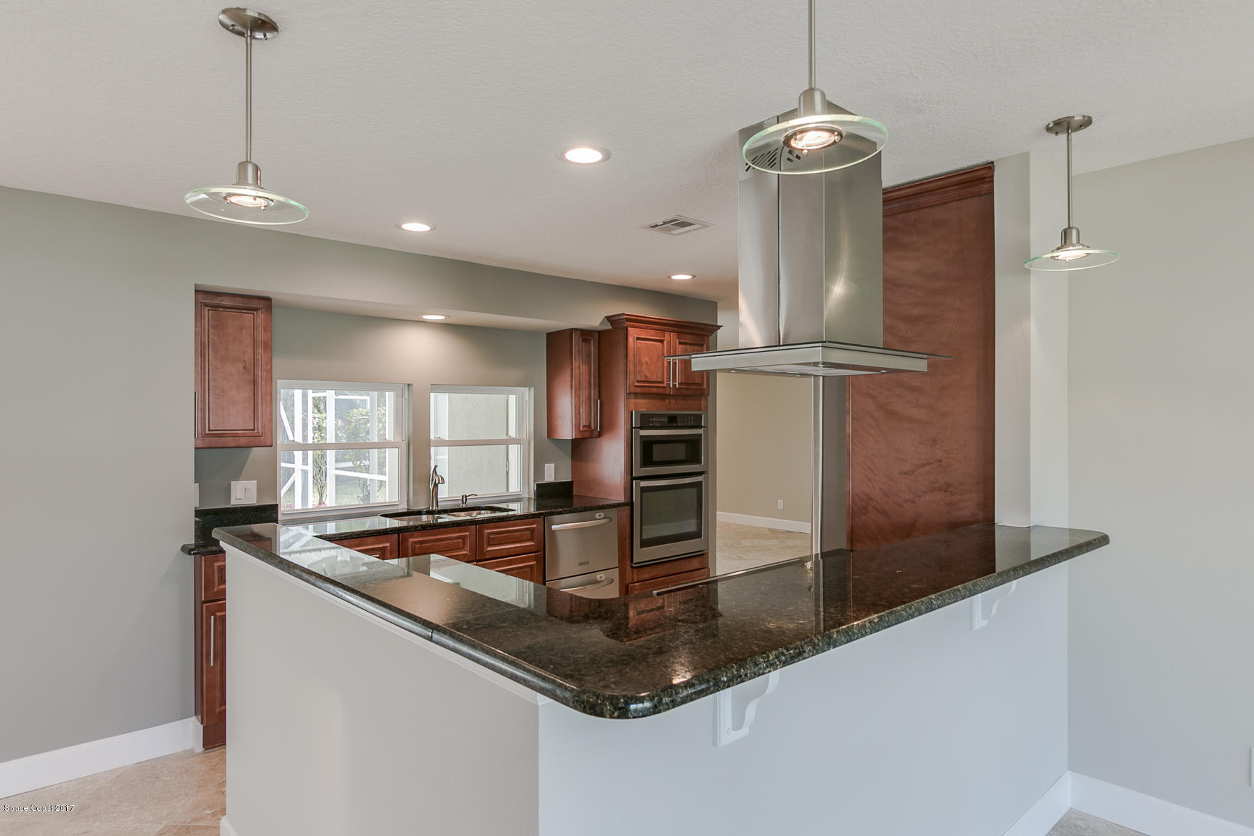515 Rio Lane Melbourne, FL 32903 - Photo 5 of 15 a kitchen with stainless steel appliances granite countertop a sink a refrigerator and a window