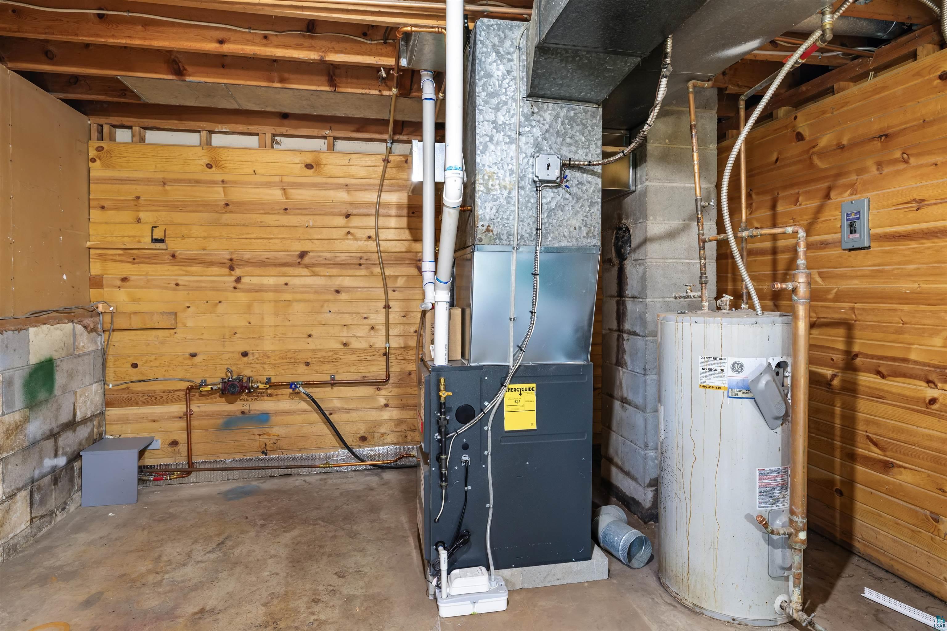 40139 County Road 251 Cohasset, MN 55721 - Photo 27 of 50 Utility area featuring exposed wood walls, concrete block foundation, a forced air propane furnace, and a hot water heater
