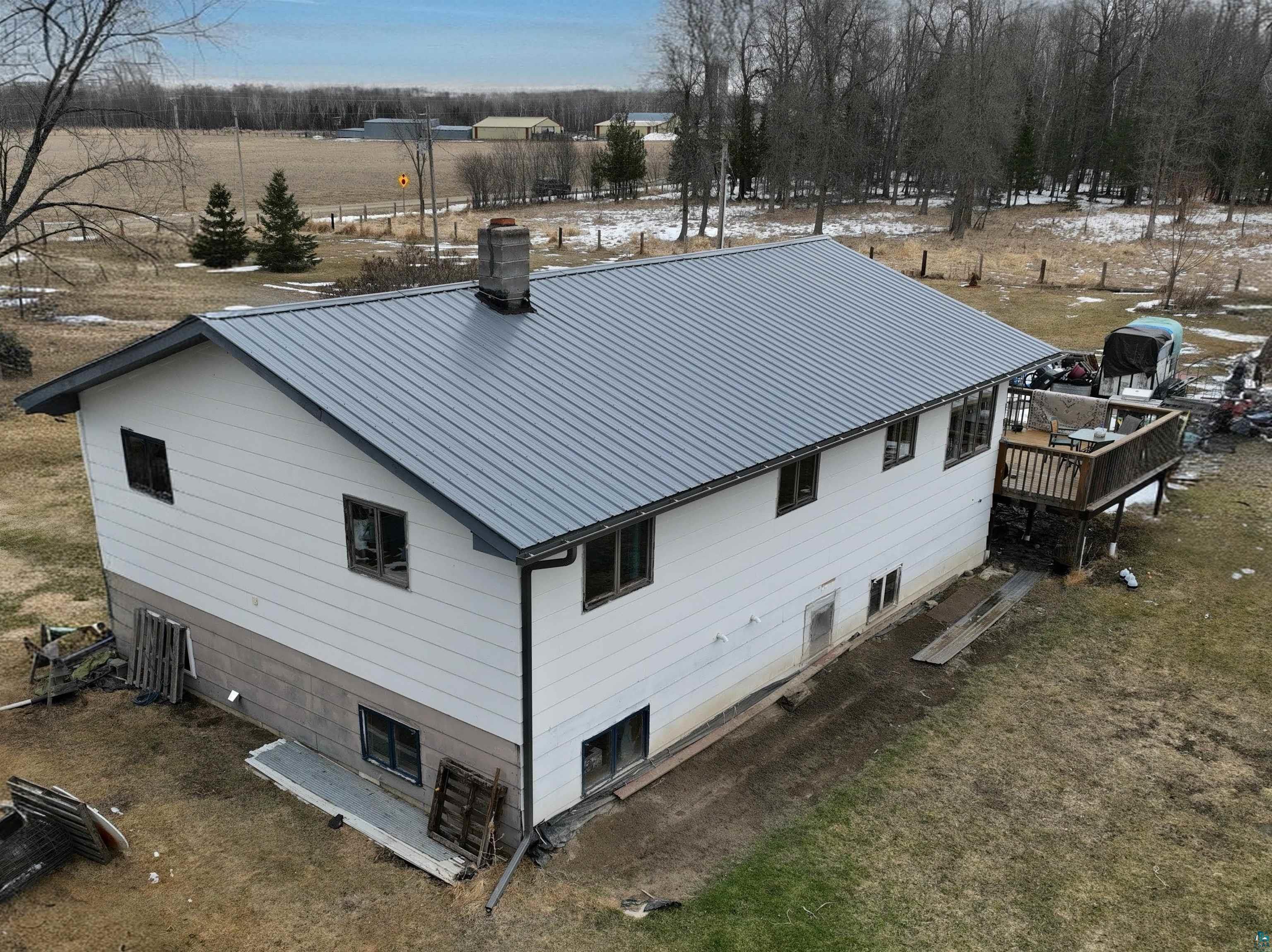 40139 County Road 251 Cohasset, MN 55721 - Photo 41 of 50 Split-entry residence featuring a metal roof, white colored siding, and dark-trimmed windows