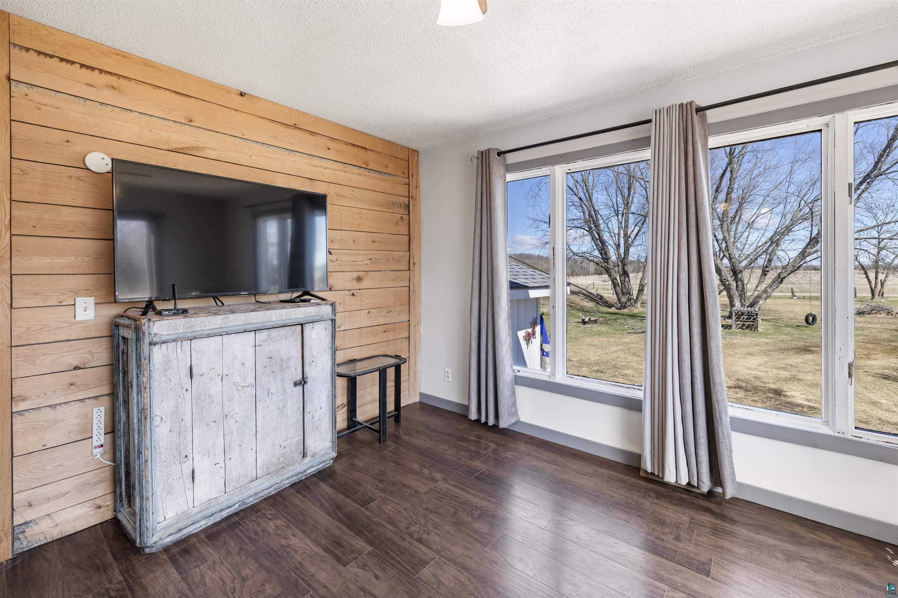 40139 County Road 251 Cohasset, MN 55721 - Photo 5 of 50 Spacious room featuring laminate flooring and a wood plank accent wall