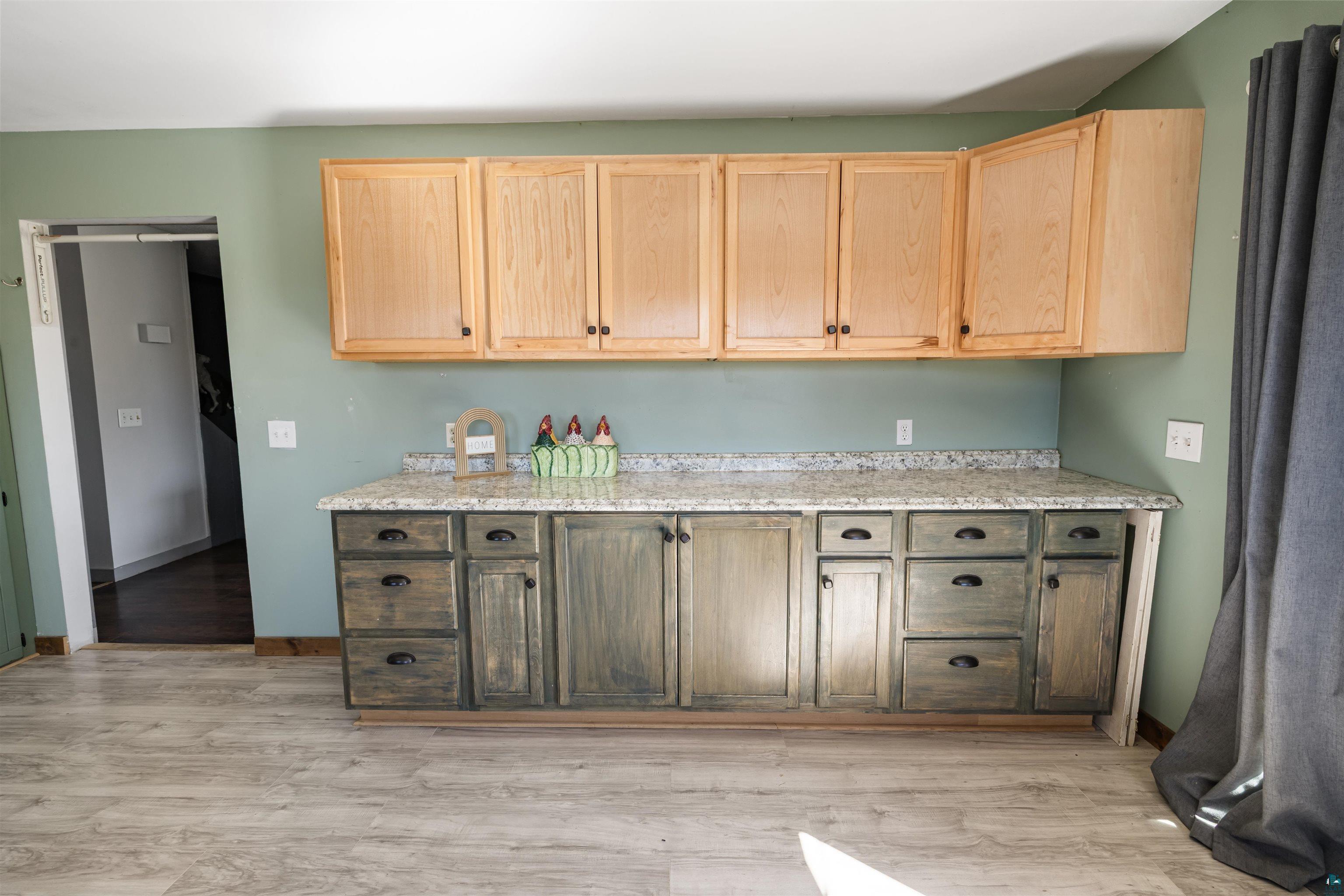 40139 County Road 251 Cohasset, MN 55721 - Photo 10 of 50 Kitchen featuring light wood-finish upper cabinetry, lower wood-finish cabinetry, and a light-toned laminate countertop