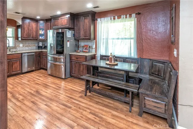 a kitchen view with a refrigerator and a sink
