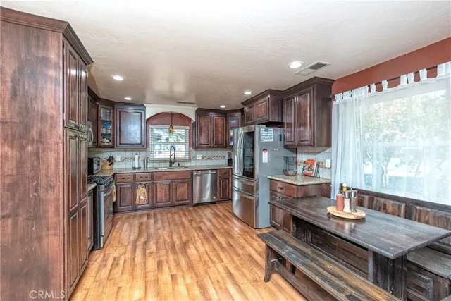 a kitchen with stainless steel appliances granite countertop a stove and refrigerator