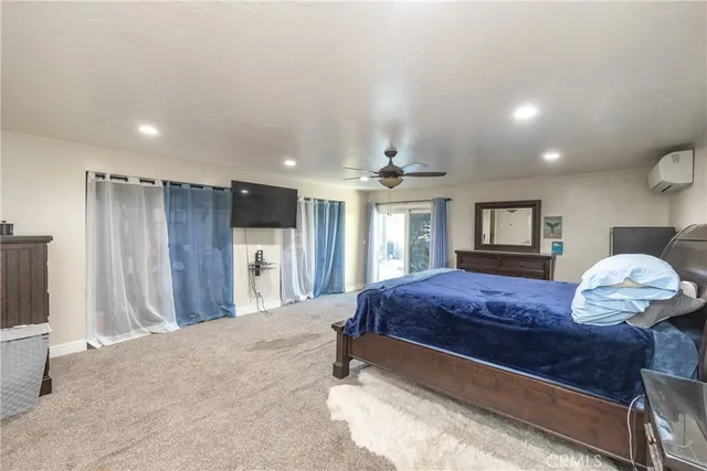 a bedroom with a large bed and a chandelier