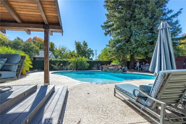 a view of a park with couches and wooden fence