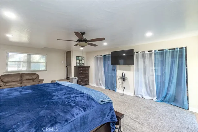 a living room with a bed furniture and a large window