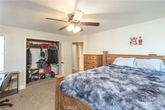 a bed room with a bed mirror and a desk