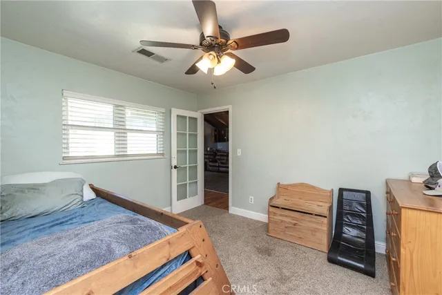 a bedroom with bed and a window