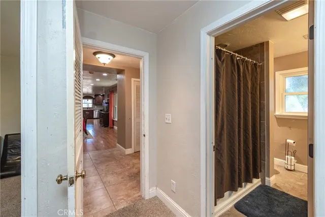 a view of a hallway with dining room and closet