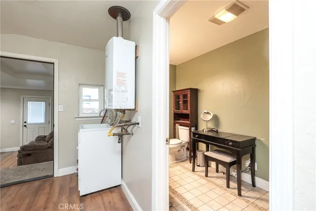 a view of hall way with furniture and wooden floor