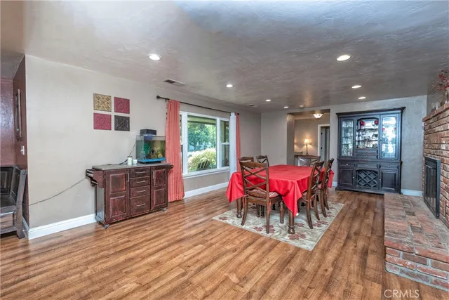 a living room with furniture a wooden floor and next to a window