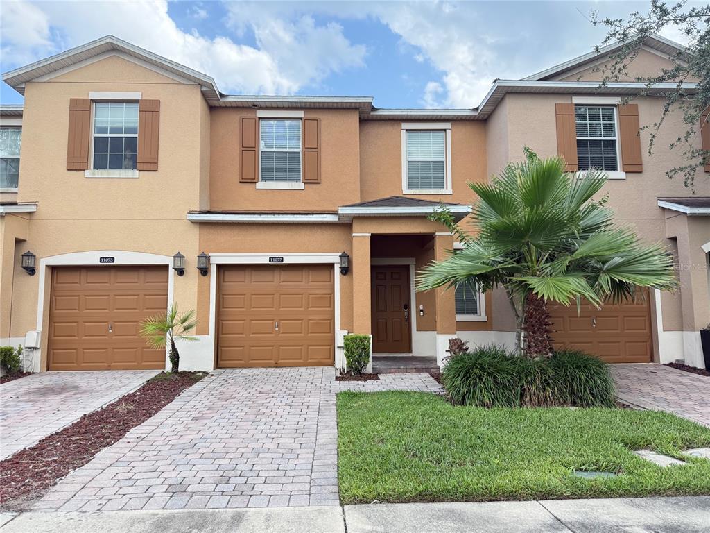 a front view of a house with a yard and garage