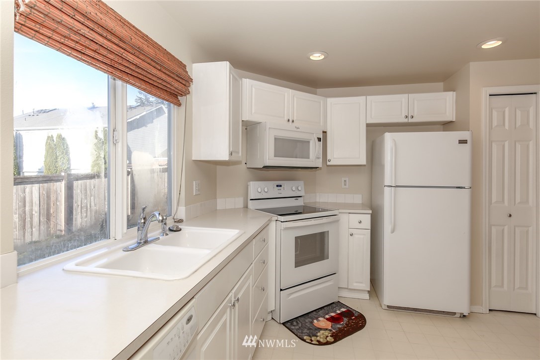 3716 Northeast 5th Place Renton, WA 98056 - Photo 11 of 29 a kitchen with a sink stove and refrigerator