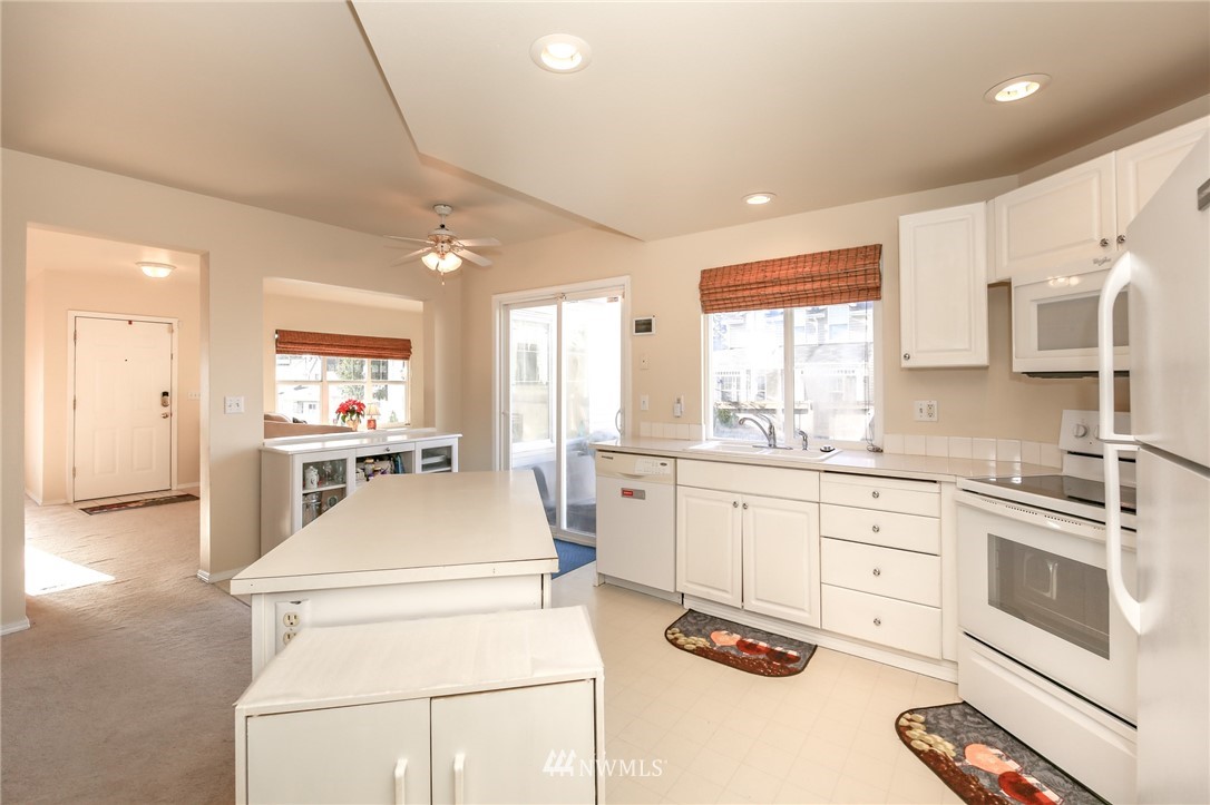 3716 Northeast 5th Place Renton, WA 98056 - Photo 16 of 29 a kitchen with a stove a sink and a refrigerator