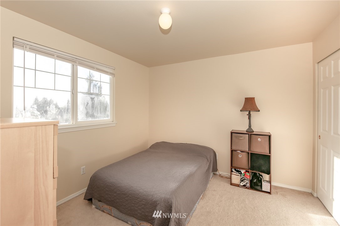 3716 Northeast 5th Place Renton, WA 98056 - Photo 17 of 29 a bedroom with a bed and a window