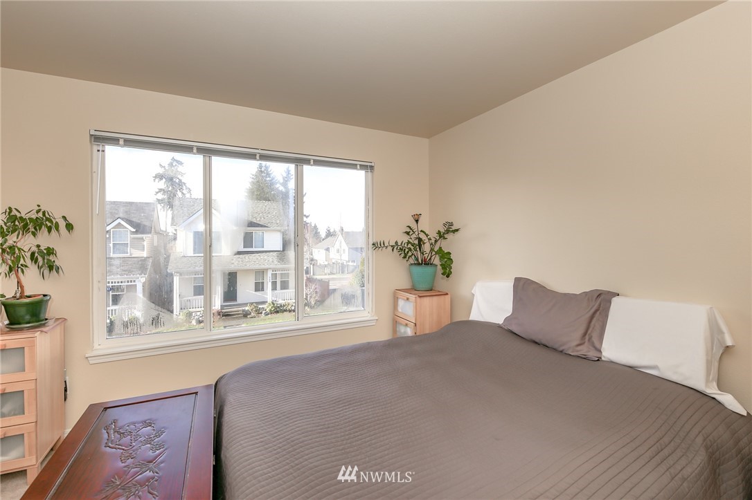 3716 Northeast 5th Place Renton, WA 98056 - Photo 24 of 29 a bed sitting in a bedroom next to a window