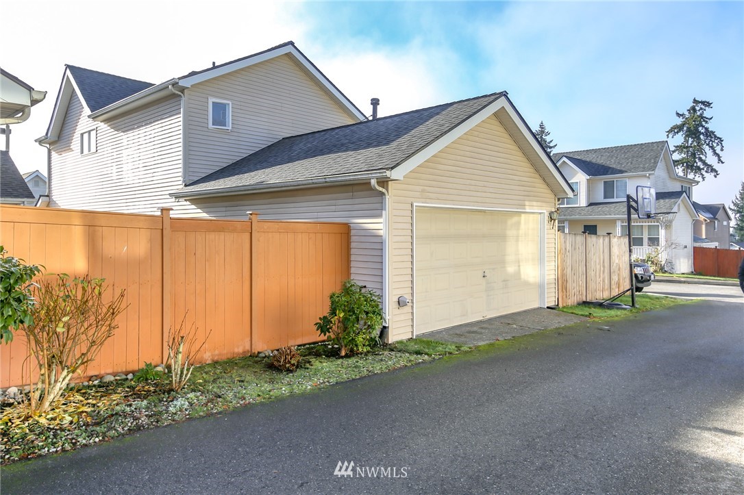 3716 Northeast 5th Place Renton, WA 98056 - Photo 26 of 29 a front view of a house with a yard and garage