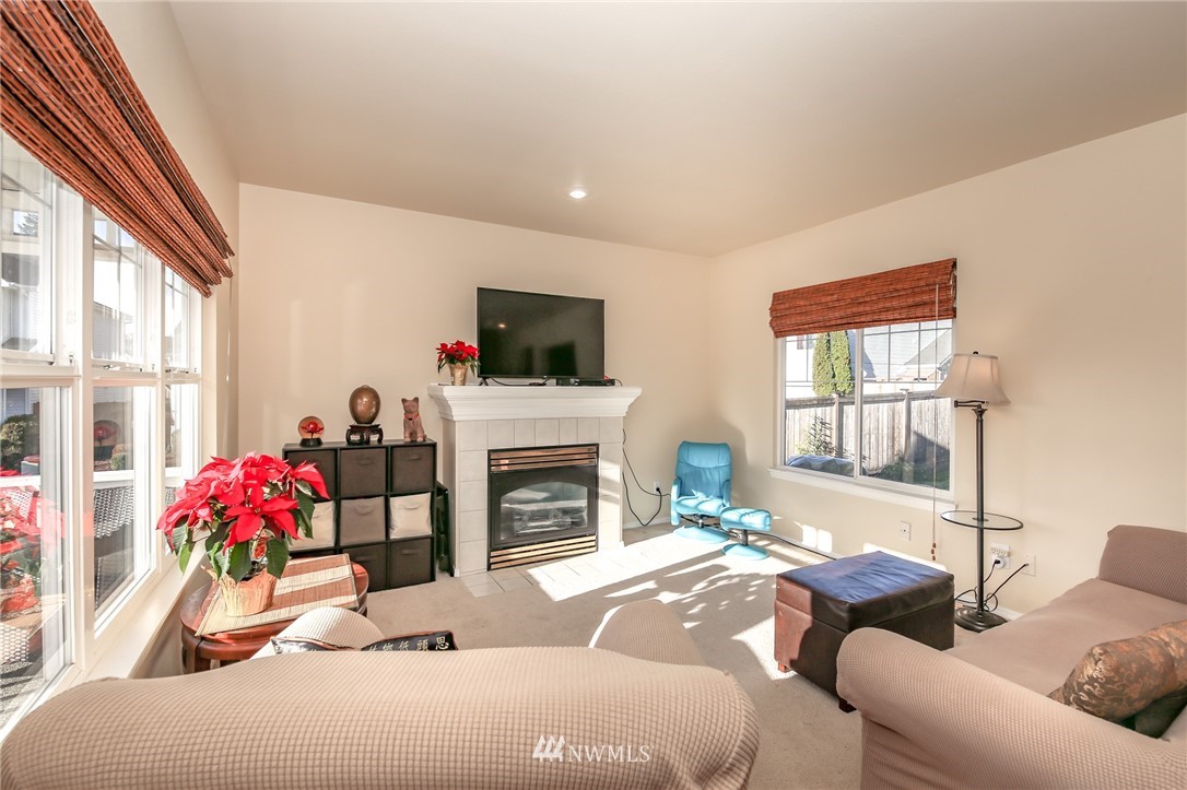 3716 Northeast 5th Place Renton, WA 98056 - Photo 5 of 29 a living room with furniture a flat screen tv and a fireplace