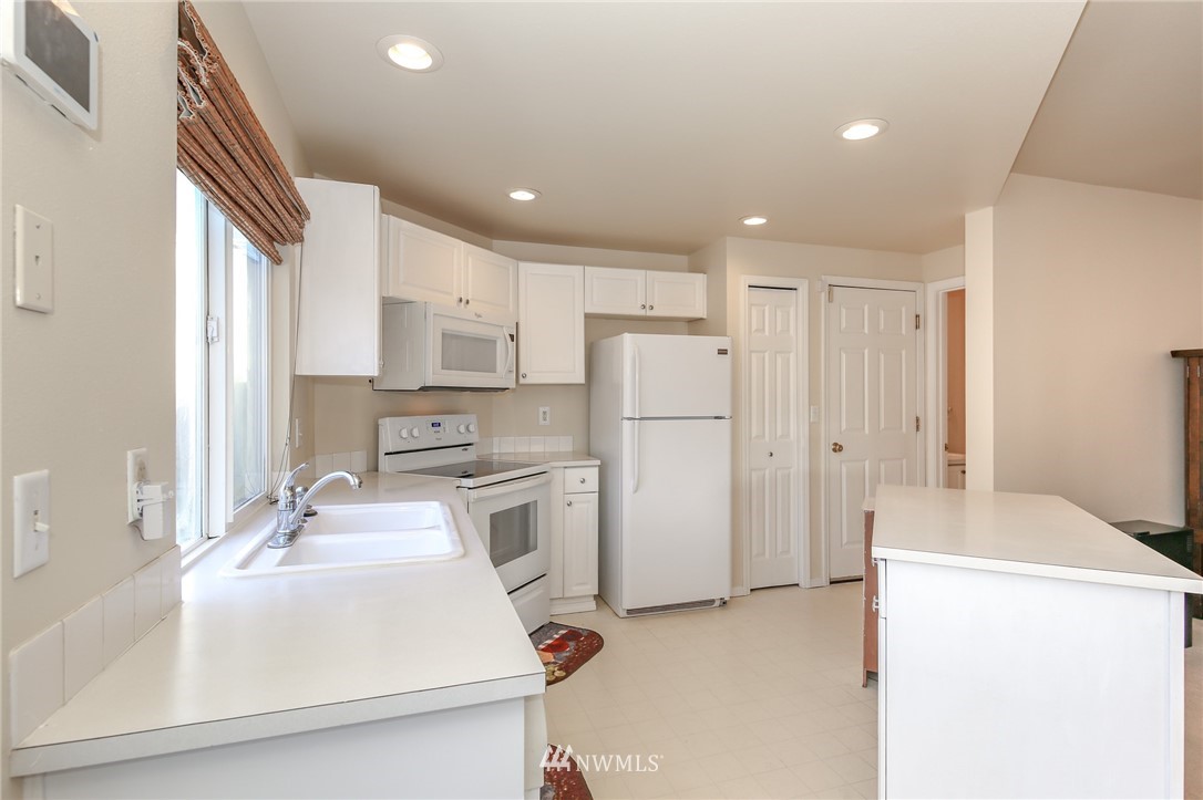 3716 Northeast 5th Place Renton, WA 98056 - Photo 10 of 29 a kitchen with refrigerator cabinets and a sink