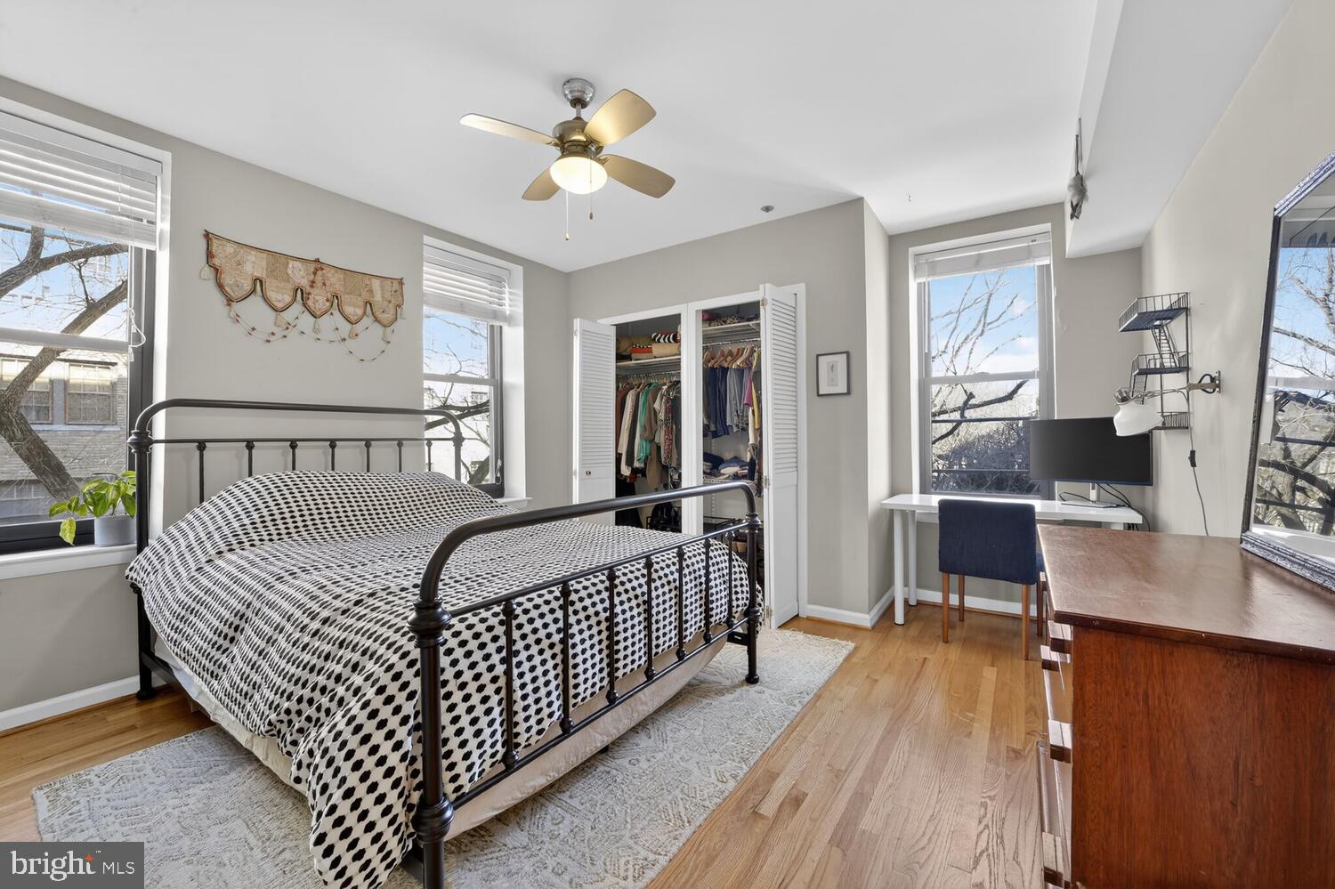 2633 Adams Mill Road Northwest, Unit 205 Washington, DC 20009 - Photo 11 of 18 a bedroom with furniture and a wooden floor