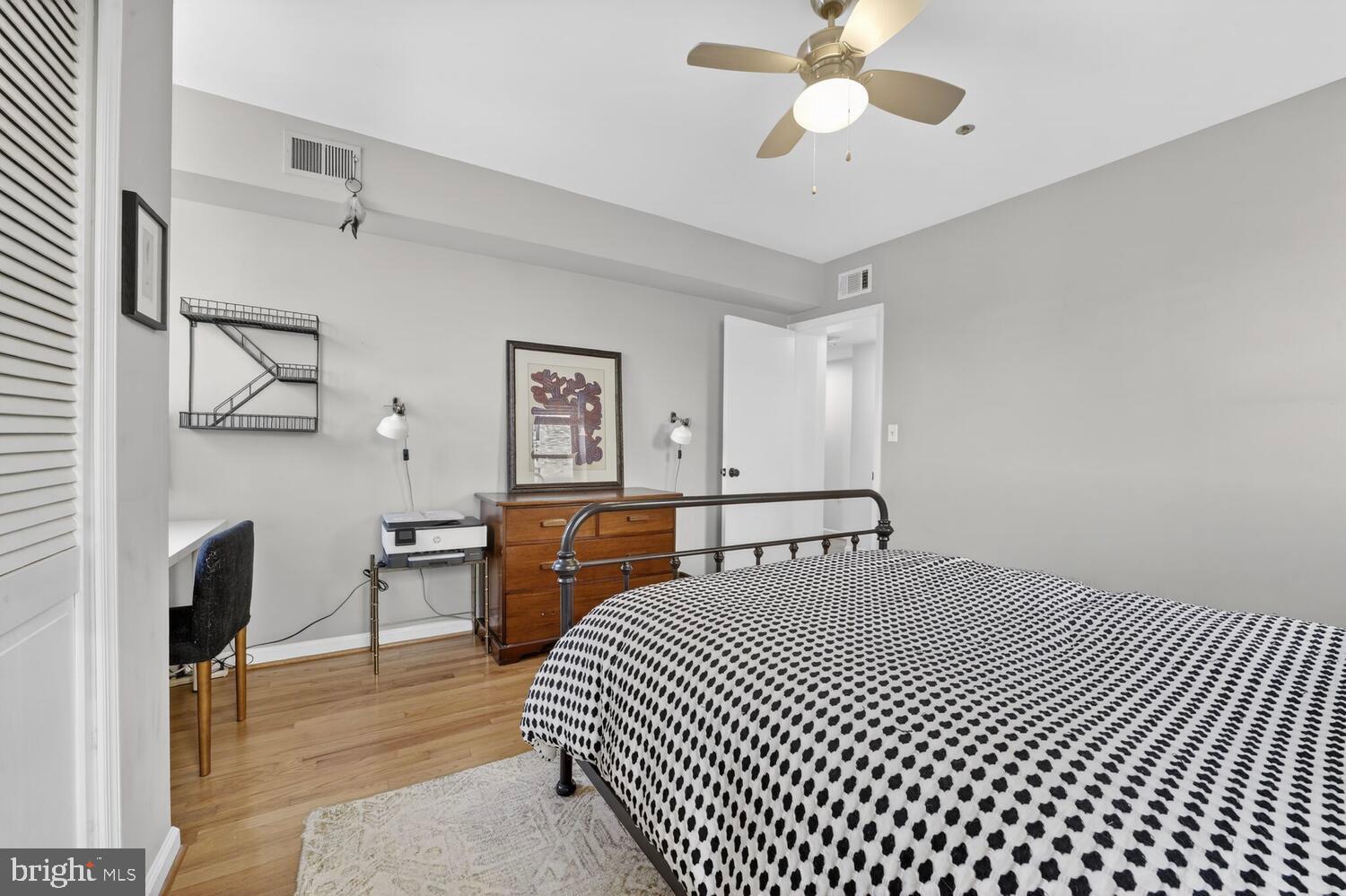 2633 Adams Mill Road Northwest, Unit 205 Washington, DC 20009 - Photo 13 of 18 a bedroom with a bed and a chandelier