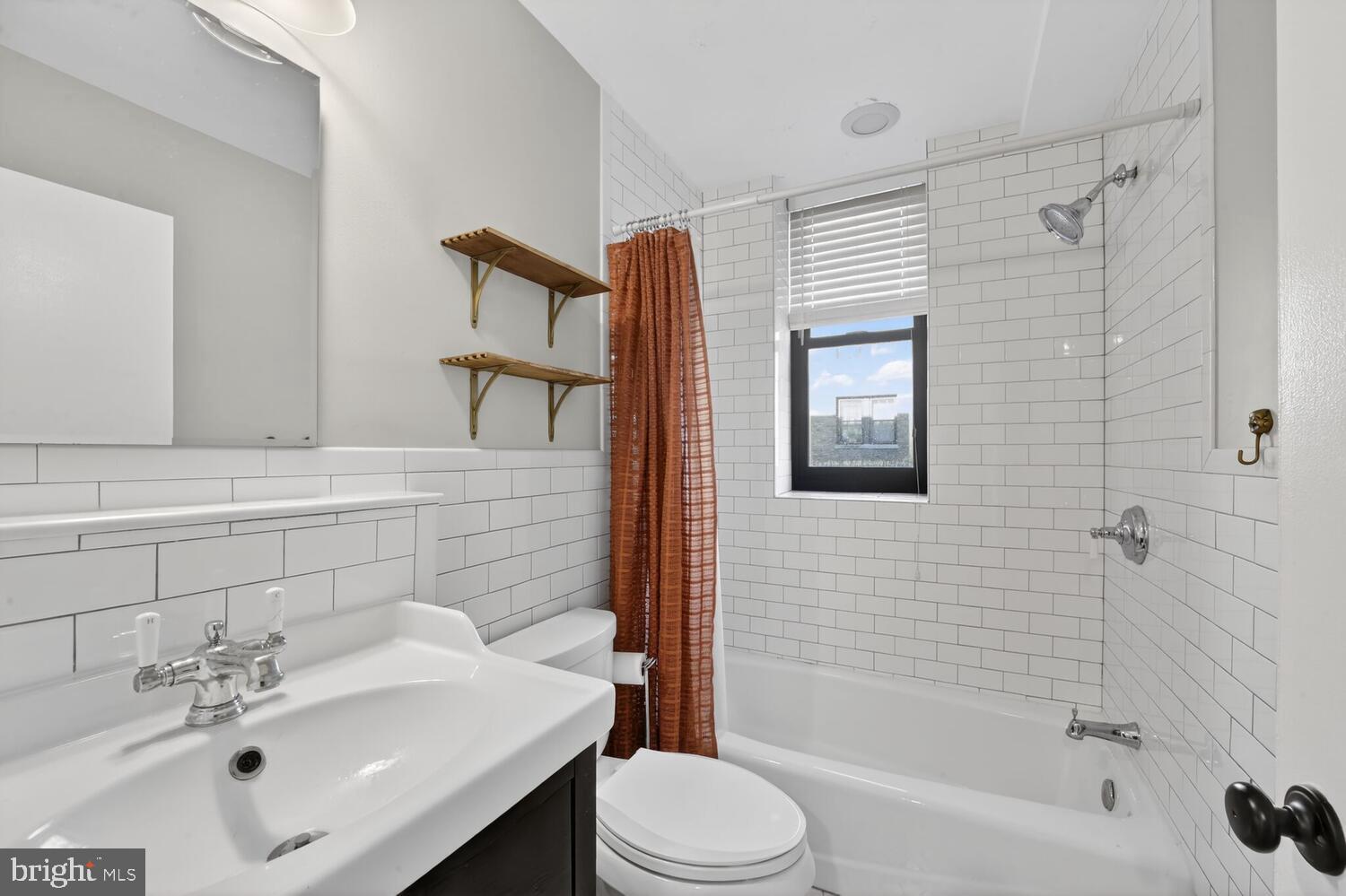 2633 Adams Mill Road Northwest, Unit 205 Washington, DC 20009 - Photo 14 of 18 a bathroom with a sink toilet and shower