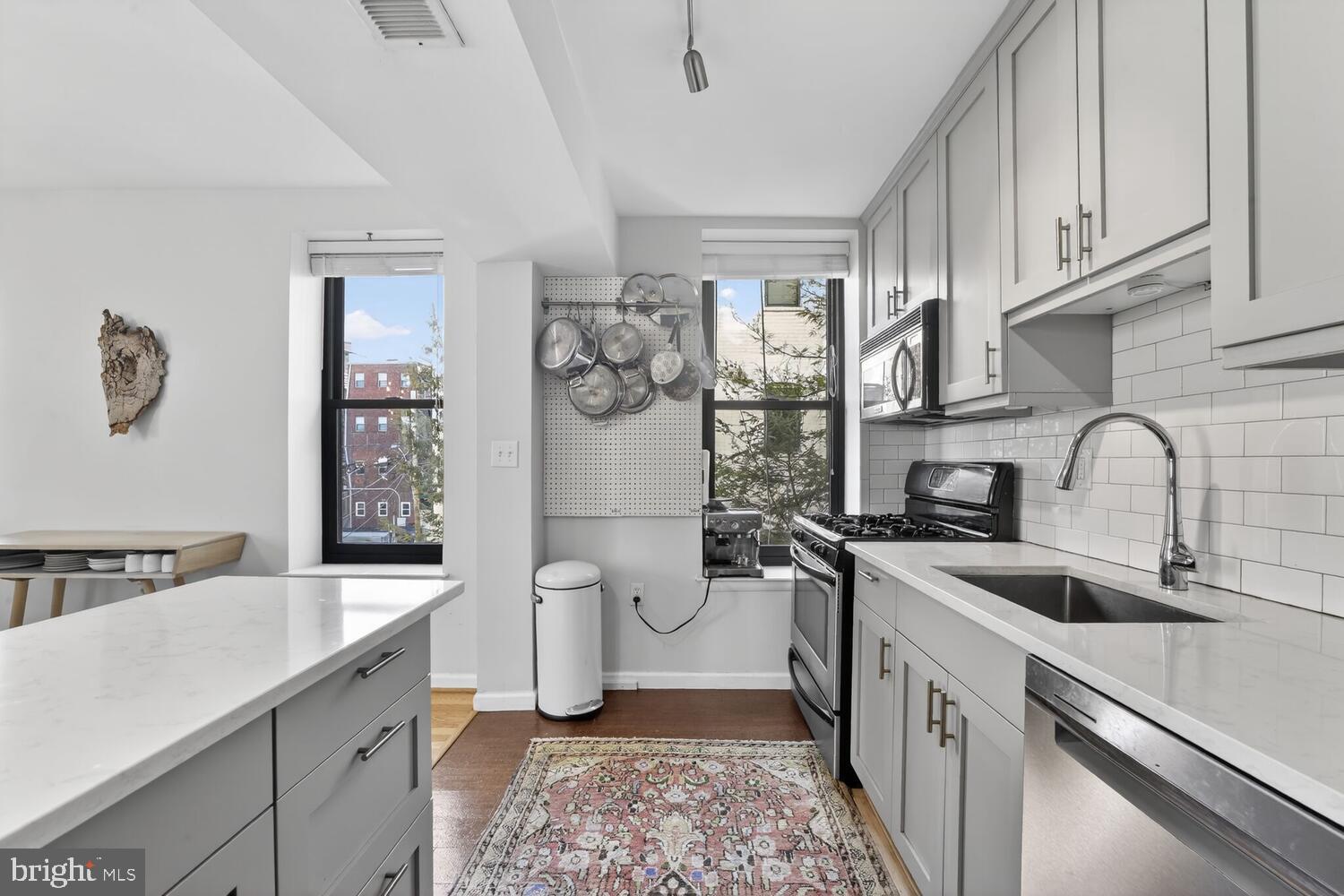 2633 Adams Mill Road Northwest, Unit 205 Washington, DC 20009 - Photo 6 of 18 a kitchen with a sink stove and cabinets