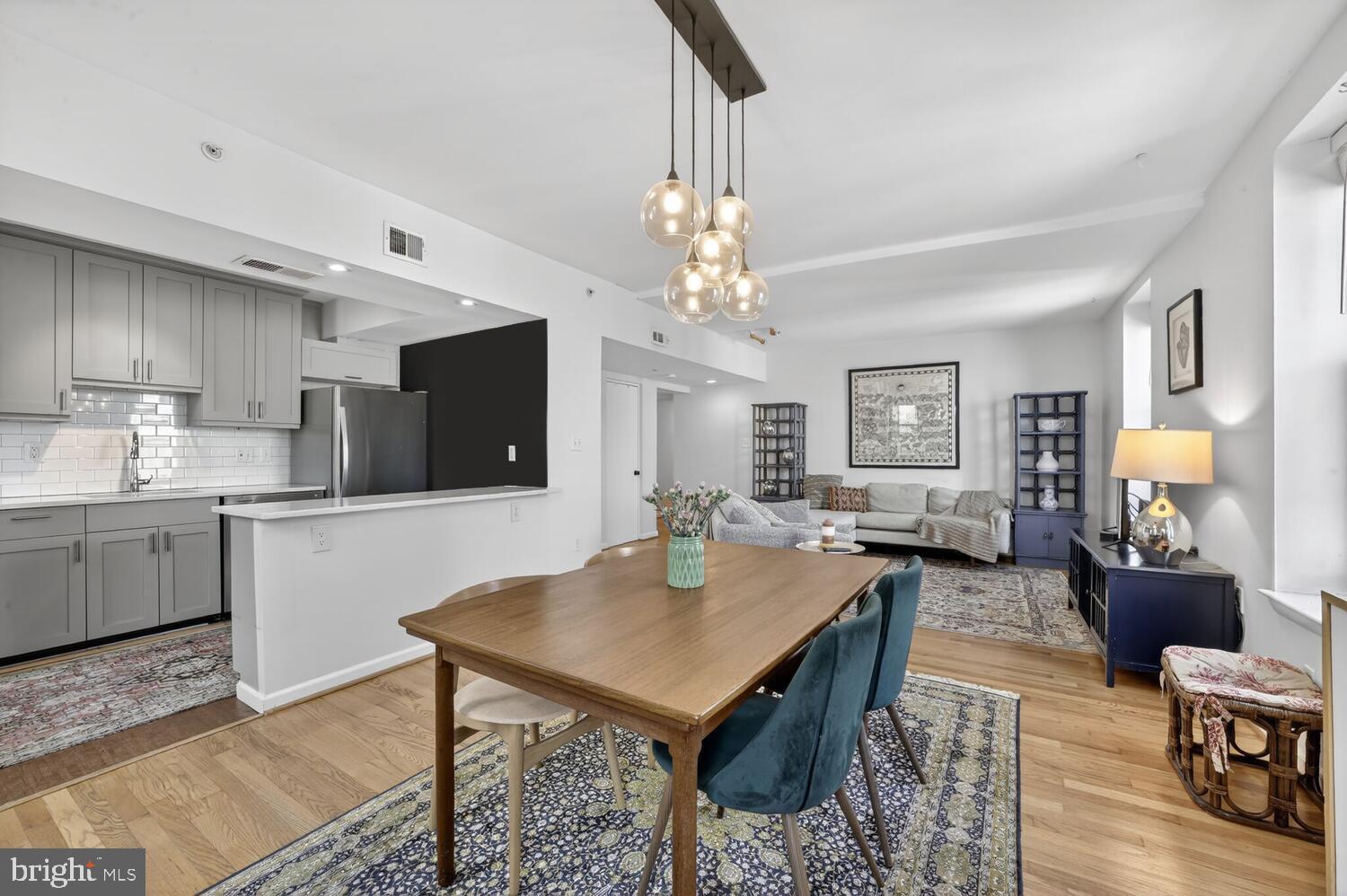 2633 Adams Mill Road Northwest, Unit 205 Washington, DC 20009 - Photo 7 of 18 a kitchen with a table and chairs in it