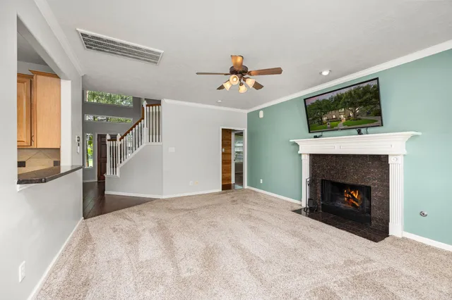 a view of an empty room with fireplace and a window