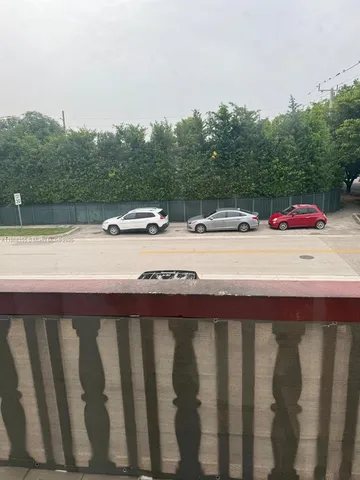a view of balcony with wooden floor and fence