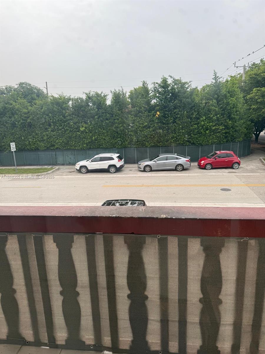 1000 West 28th Street, Unit 15 Hialeah, FL 33010 - Photo 2 of 10 a view of balcony with wooden floor and fence