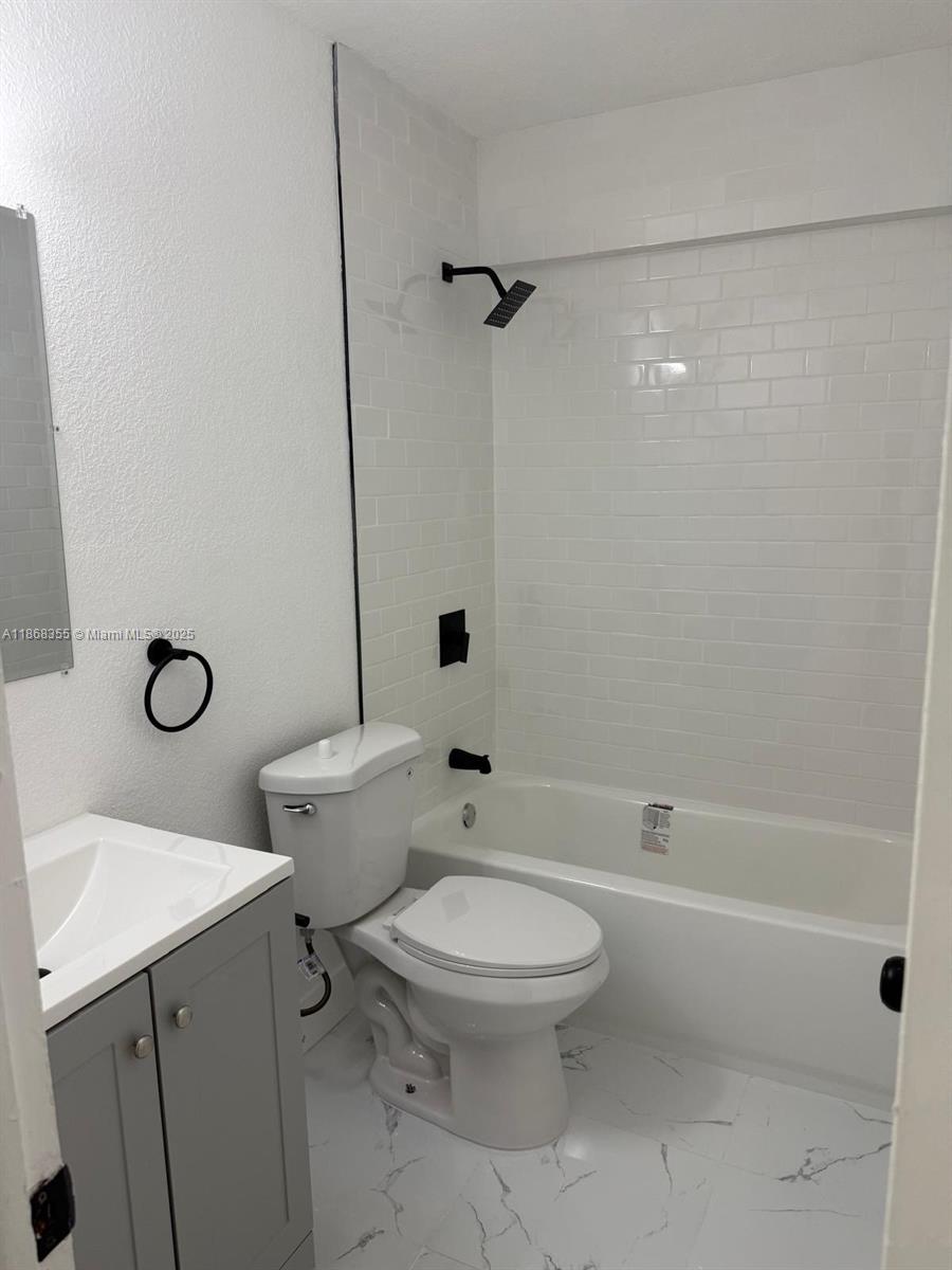 1000 West 28th Street, Unit 15 Hialeah, FL 33010 - Photo 6 of 10 a white toilet sitting next to a bath tub
